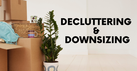 decluttering and downsizing text with picture of stacked cardboard boxes and plant